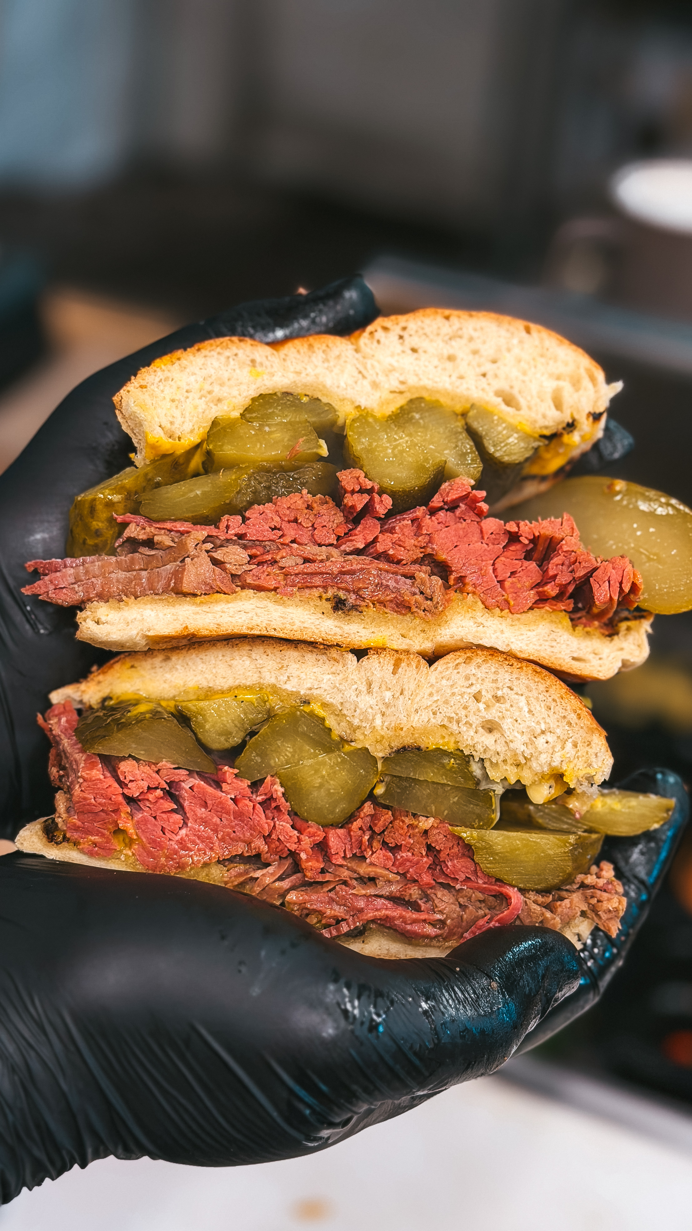 A spiced beef sandwich from On the Hoof in Cork, filled with sliced beef and pickles on toasted bread.